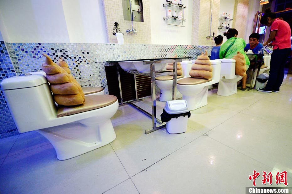 A toilet-themed restaurant opened in Taiyuan, north China’ Shanxi province on Aug. 28, 2013. Everything in the restaurant is absolutely toilet related; food and drink are served from mini toilet bowl or urinals; diners seat on toilet seats; toilet paper rolls are hung on the wall to replace table tissues. The decoration in toilet style offers a funny dining experience, which attracted lots young people to visit. (Photo/CNS)