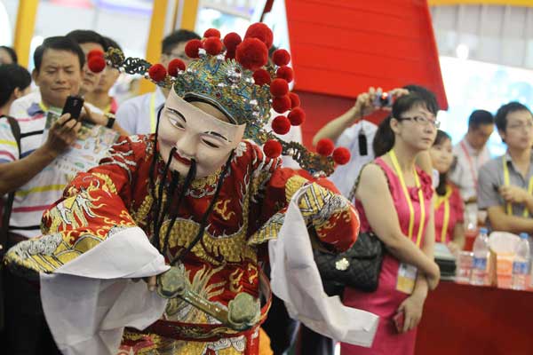A "god of fortune" extends his good wishes at a ceremony to mark the start of the 17th China International Fair for Investment and Trade on Sunday in the coastal city of Xiamen, Fujian province. More than 670 delegations from 100 countries and regions are attending the fair. Zhu Xingxin / china daily