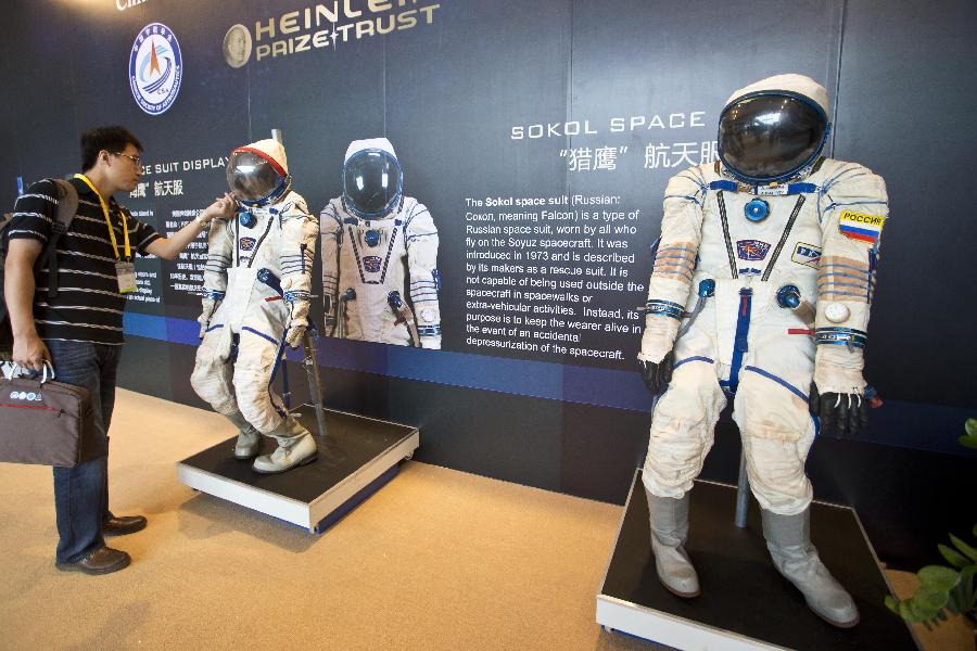 A visitor views the "Sokol" spacesuits during the 64th International Astronautical Congress (IAC 2013) in Beijing, capital of China, Sept. 23, 2013. The congress, which kicked off on Monday, displayed the latest achievements of aerospace industry, attracting aerospace enterprises from home and abroad. (Xinhua/Zhao Bing)