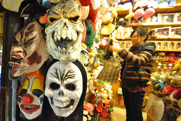 Masks, costumes and other Halloween-related merchandise are displayed at a store in Handan, Hebei province, on Wednesday, the day before the celebration. Halloween has become more popular in China, but some of its scarier masks and costumes cause concern that they may affect children negatively. He Qunying / For China Daily