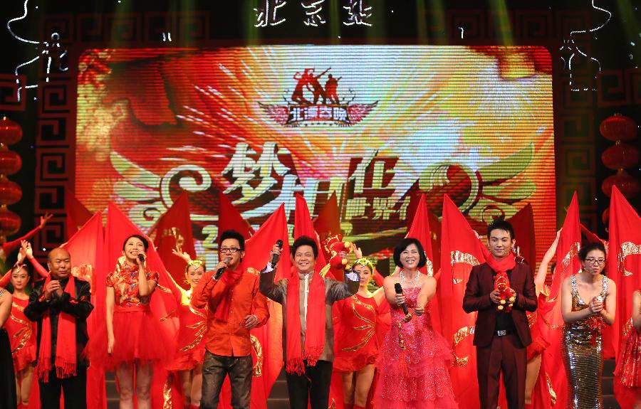 Performers wish the audiences a happy new year during a spring festival gala held for beijing drifters in Beijing, capital of China, Jan. 14, 2013. (Xinhua/Wang Zhen)