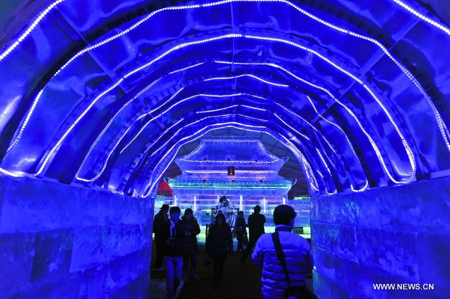 Visitors view ice lanterns during the ice lantern festival in Olympic Park in Beijing, capital of China, Jan. 23, 2014. (Xinhua/Wang Jingsheng)