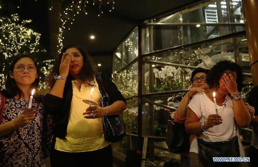 People pray for passengers on missing MH370 in Malaysia