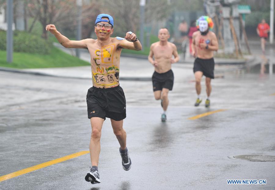 People wearing underwear take part in a running race in Nanjing, capital of east China's Jiangsu Province, March 29, 2014. A special race was held here on Saturday, in which participants wore only underwear so as to advocate the 2014 Earth Hour event and promote the concept of green lifestyle. (Xinhua/Shen Peng) 