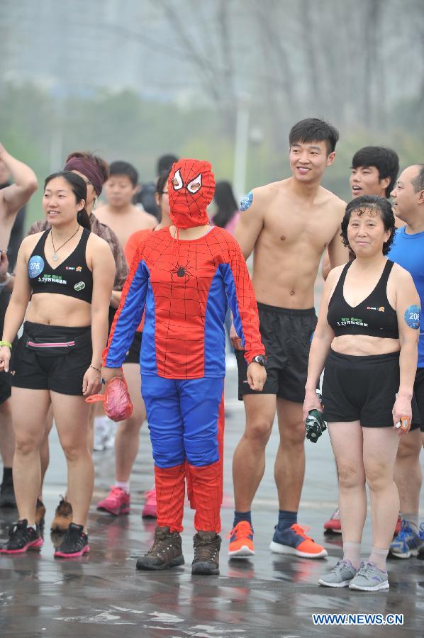 A runner in spiderman's costume takes part in a running race in Nanjing, capital of east China's Jiangsu Province, March 29, 2014. A special race was held here on Saturday, in which participants wore only underwear so as to advocate the 2014 Earth Hour event and promote the concept of green lifestyle. (Xinhua/Shen Peng) 