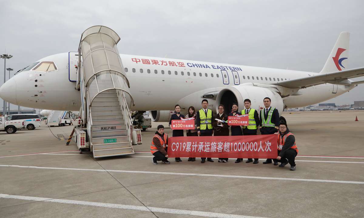 A passenger surnamed Lin, who took a flight from Shanghai Hongqiao International Airport to Xi'an Xianyang International Airport, takes a group photo with a model of the C919 as a memento of her trip as the millionth passenger on December 19, 2024. Photo: Courtesy of China Eastern Airlines