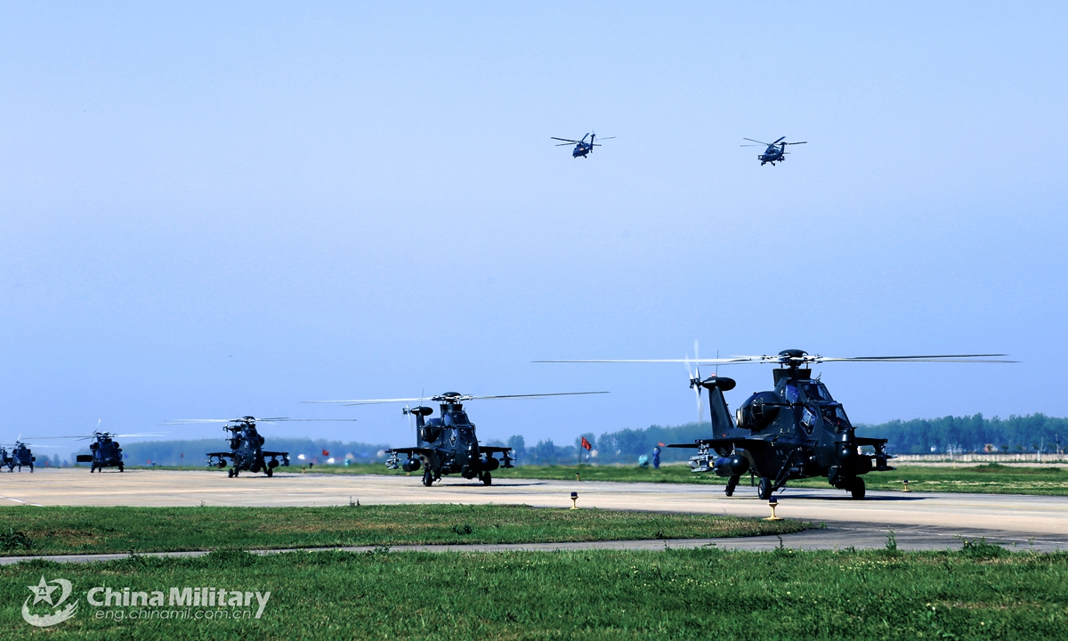 Attack helicopters attached to a naval aviation brigade under the PLA Eastern Theater Command sit in formation on the parking apron during a flight training exercise in April 19,2021. Photo:China Military
