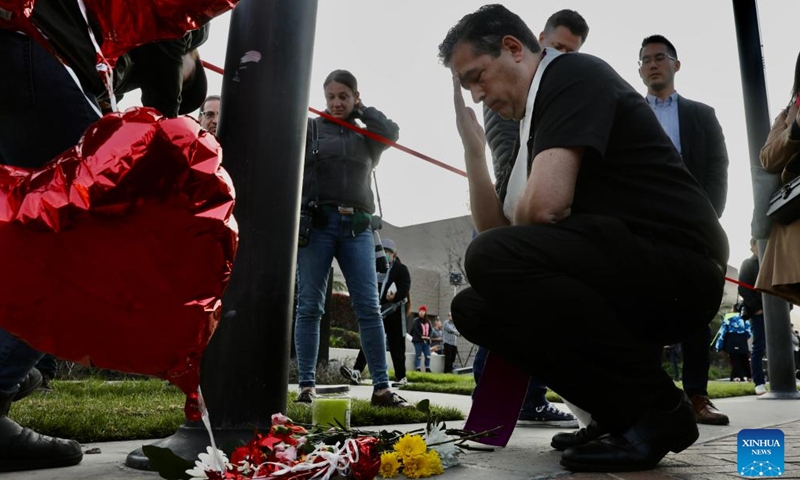 People mourn for victims of a mass shooting in front of the city hall of Monterey Park, California, the United States, Jan. 22, 2023. Five women and five men were killed while another 10 people were injured in a mass shooting in the city of Monterey Park, 16 km east of Los Angeles downtown, the authorities said Sunday.(Photo: Xinhua)