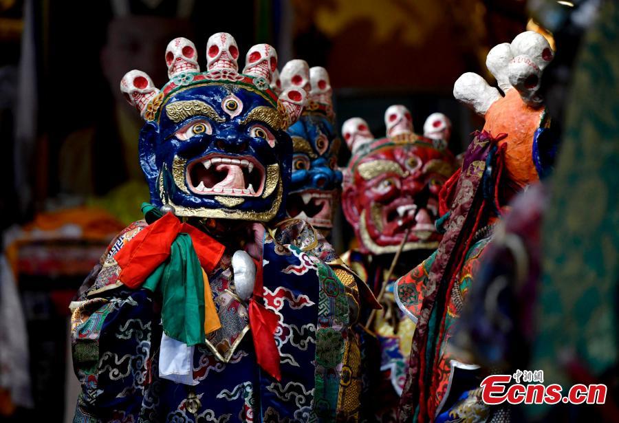 Monks perform Cham dance to greet Tibetan New Year