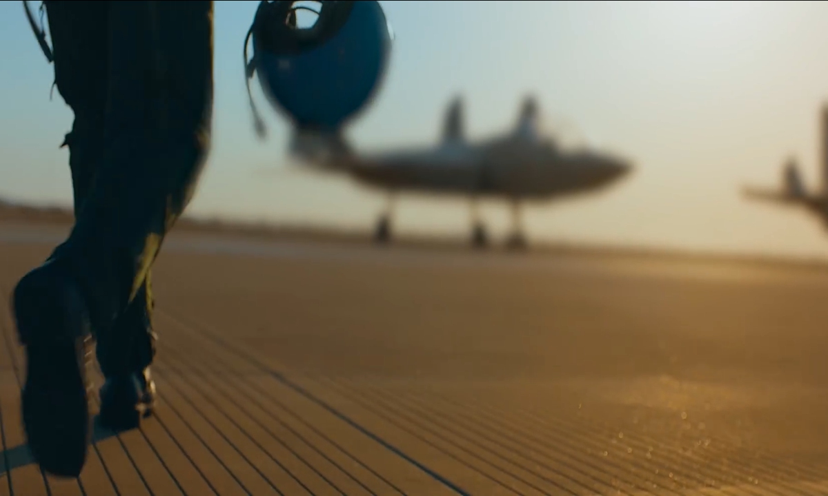 A pilot walks toward an unidentified aircraft in a promotional video on carrier-based pilot recruitment released by the Chinese People's Liberation Army (PLA) Navy on February 27, 2023. Observers say it could be China's next-generation carrier-based fighter jet. Photo: Screenshot of the PLA Navy promotional video