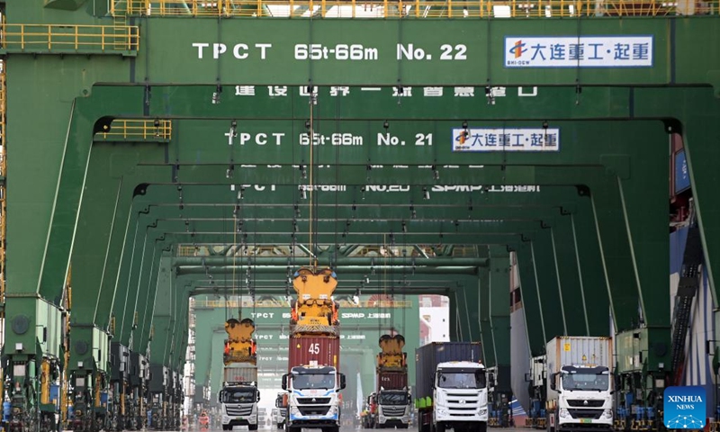 Containers are transported by trucks at the Pacific international container terminal of Tianjin Port in north China's Tianjin, April 11, 2023. North China's Tianjin Port handled approximately 5.047 million twenty-foot equivalent units (TEUs) of containers in the first three months of 2023, up 9.09 percent year on year.(Photo: Xinhua)