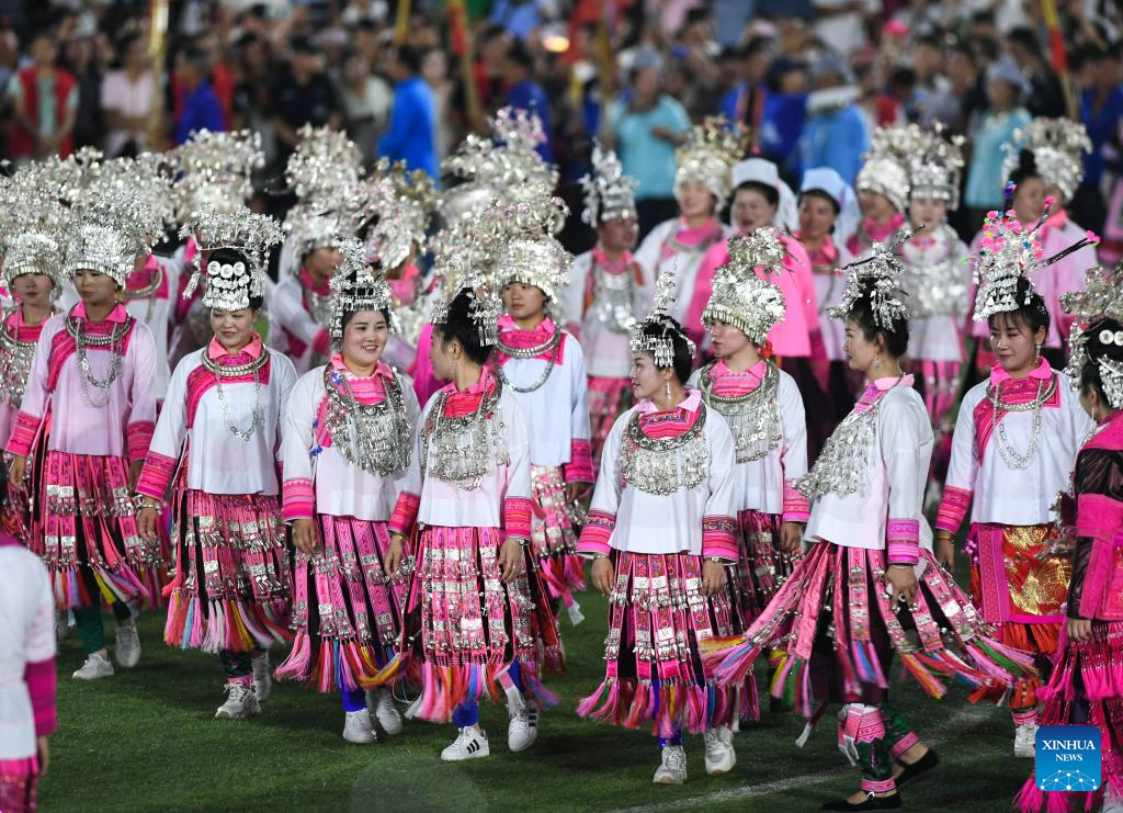 Villagers in ethnic dress give performance for "Village Super League" football match in Guizhou