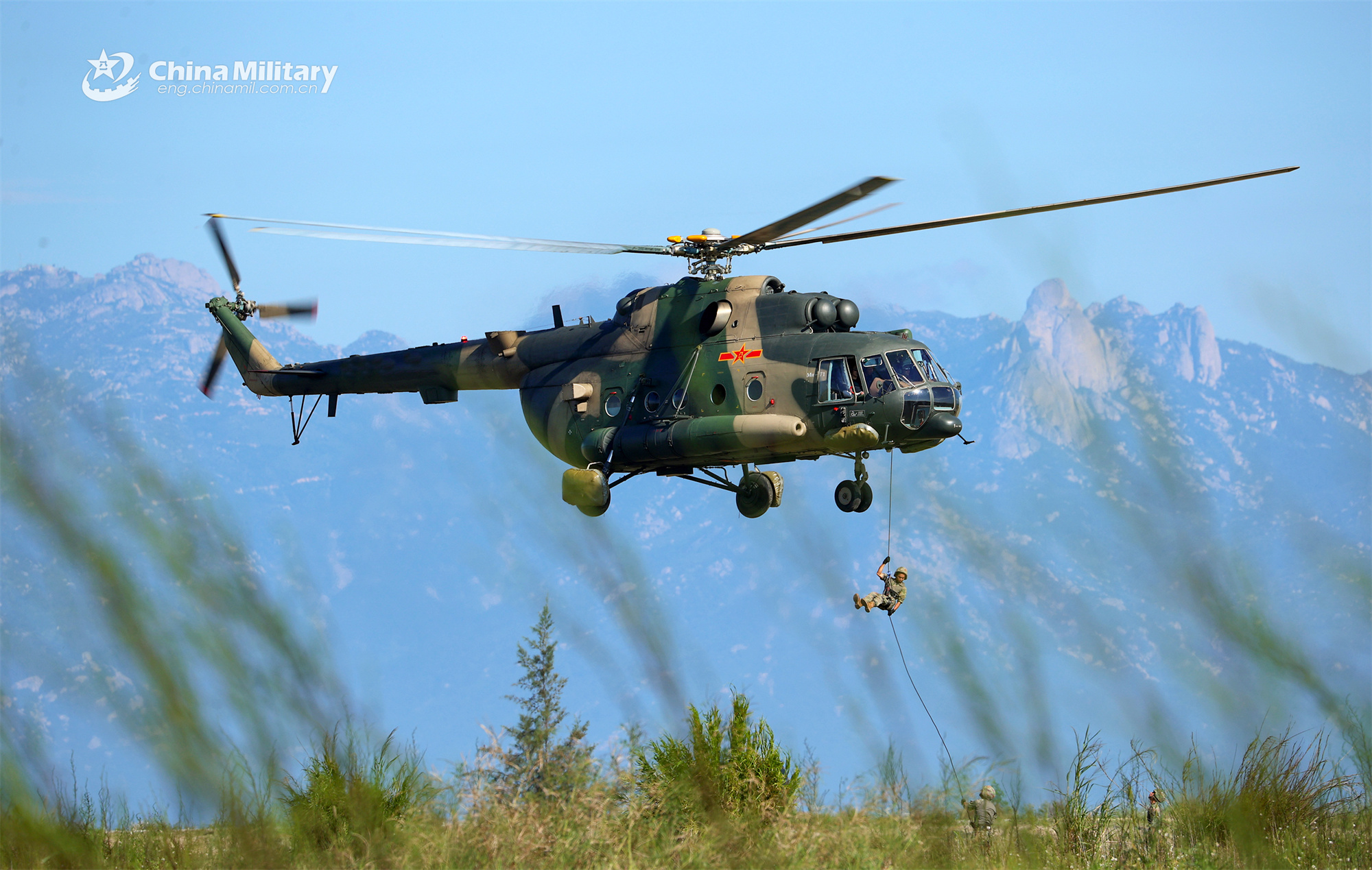 Soldiers fast rope from transport helicopters