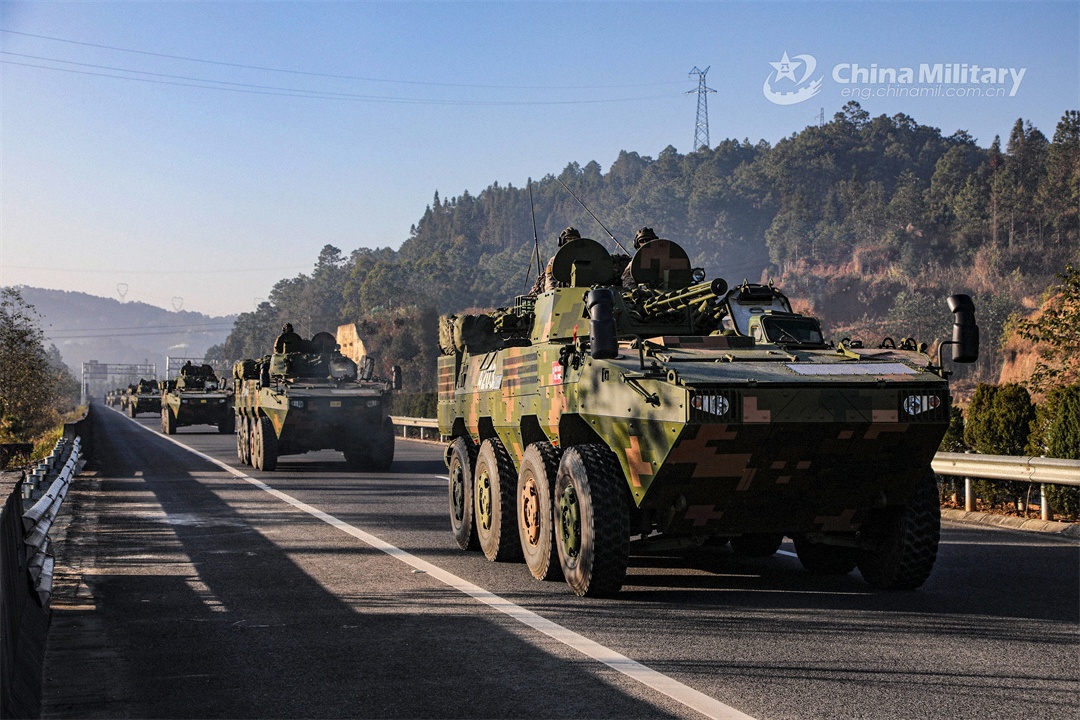 Armored vehicles maneuver on intercity highway