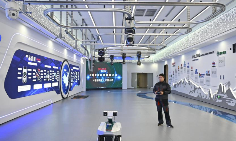 A staff member displays an inspection robot at a test base in the Xiong'an Science and Technology Innovation Center in Xiong'an New Area, north China's Hebei Province, March 28, 2024. In April 2017, China announced a plan to establish the Xiong'an New Area, which spans the Rongcheng, Anxin and Xiongxian counties, as well as some adjacent areas in north China's Hebei Province.The new area aims to relieve Beijing of non-essential functions related to its status as the nation's capital, while also advancing the coordinated development of the Beijing-Tianjin-Hebei region.The country has also vowed to build Xiong'an, dubbed the city of the future, into an innovative, green, smart and world-class city with blue skies, fresh air and clean water, in line with the country's high-quality development path. (Xinhua/Mu Yu)