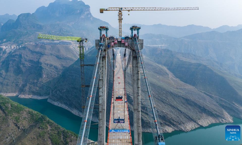 An aerial drone photo taken on April 28, 2024 shows the construction site of Zangke River bridge on Nayong-Qinglong Expressway in southwest China's Guizhou Province. The closure of the bridge, featuring a length of 1,849 meters and a span of 1,080 meters, has been successfully completed on Sunday.(Photo: Xinhua)