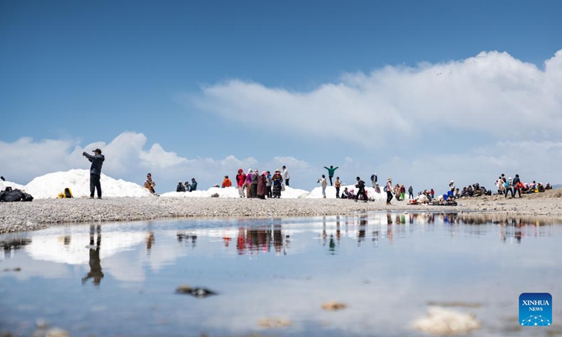 Tourists enjoy the scenery by the Lake Namtso in southwest China's Xizang Autonomous Region, May 19, 2024. As temperature rises and ice melts, the Lake Namtso will enter its tourism season. Photo: Xinhua