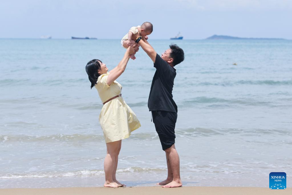 Tourists enjoy themselves in Sanya