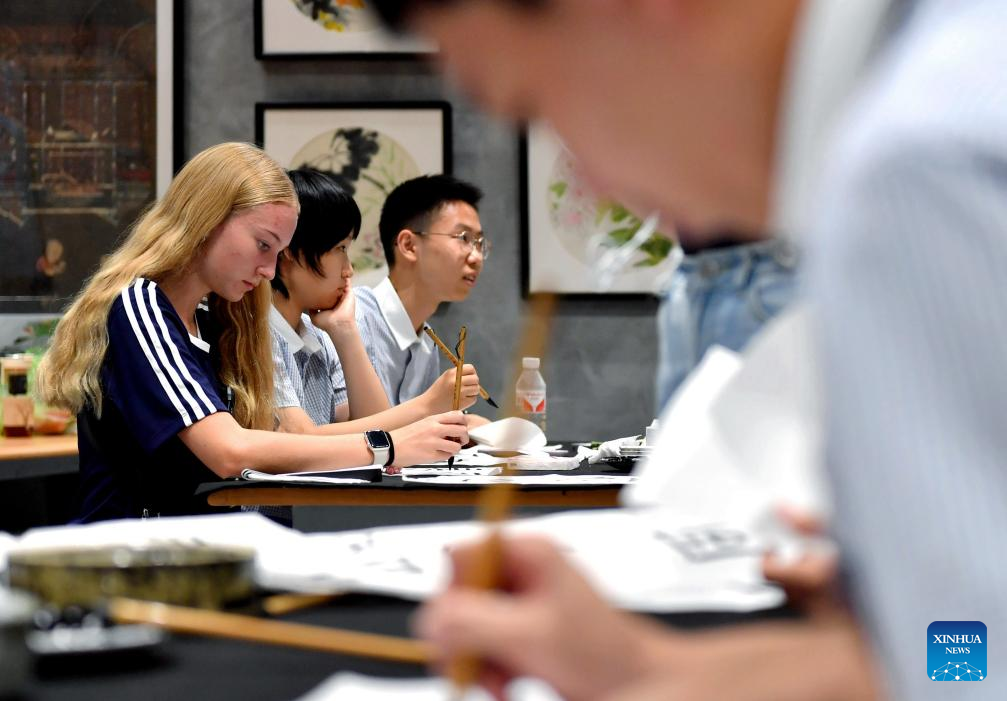 US students and teachers experience Chinese culture at the Qixi Festival in Hebei, northern China