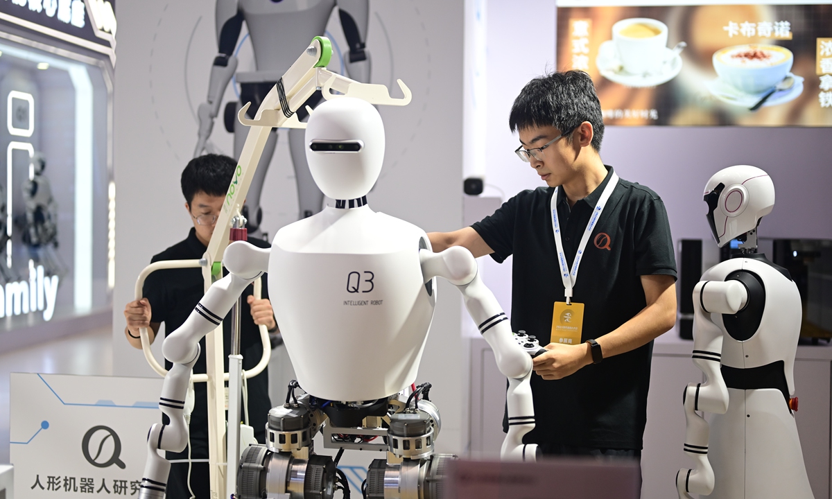 A staff checks humanoid robot at the World Robot Conference 2024 on August 21, 2024. Photo: Tao Mingyang/GT