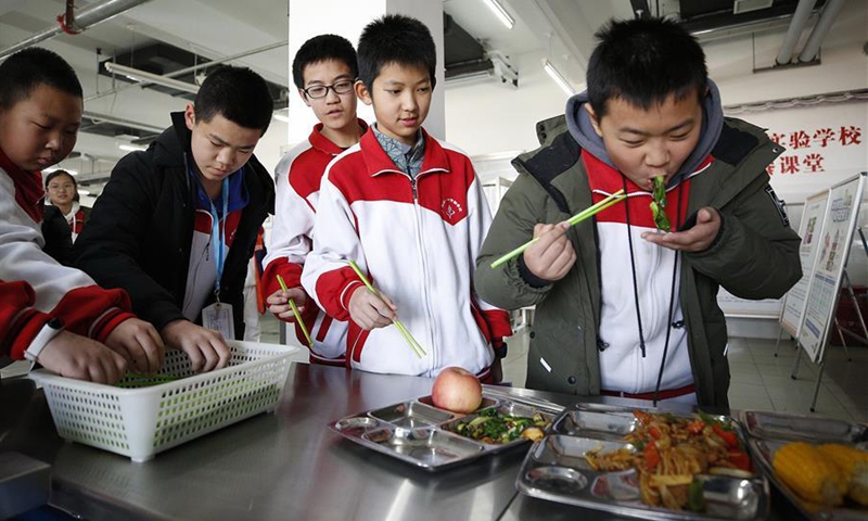 Students taste food during a nutritious catering class steming from the implementation of the Nutrition School project in the school kitchen of the Experimental School Affiliated to Niulanshan First Secondary School in Shunyi District of Beijing, capital of China, Dec. 20, 2019. Under the guidance of the disease control bureau under the National Health Commission, the National Institute for Nutrition and Health under the Chinese Center for Disease Control and Prevention, the Beijing Center for Disease Prevention and Control and the center for disease prevention and control of Shunyi District launched the Nutrition School pilot project to explore new methods that can help students change their eating habits and become healthier in 2016. The UN Children's Fund (UNICEF) supported the preliminary research work of the project, including through financial and technical support, and promoted obesity intervention in all aspects. Starting from the year of 1979, the UNICEF has invested over 675 million US dollars for improving the living condition and education for Chinese children on over 160 programmes cooperated with the Chinese government. (Xinhua/Zhang Yuwei)