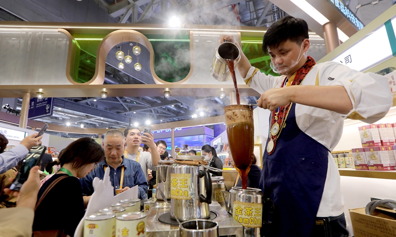 Visitors explore the Hong Kong food exhibitions and try specialties at the 7th China International Import Expo in Shanghai on November 6, 2024. Photo: Chen Xia/GT