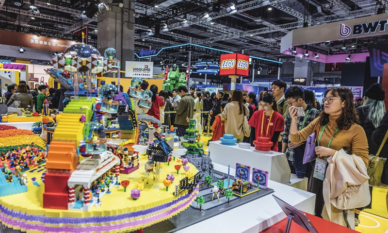 Visitors browse products and take photos at the LEGO booth in the consumer goods exhibition area at the 7th CIIE in Shanghai on November 7, 2024. The exhibition spans over 80,000 square meters, featuring more than 700 companies from more than 70 countries and regions.Photo: Li Hao/GT