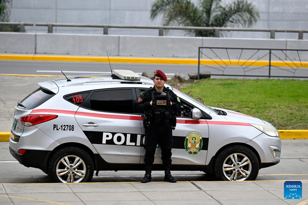 Police officers guard outside Lima Convention Center before APEC meeting