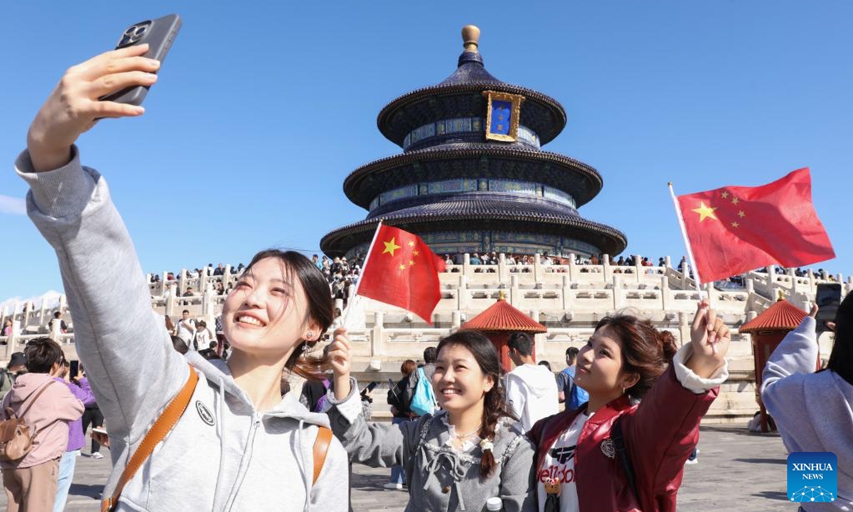 Tourists take selfies at Tiantan (Temple of Heaven) Park in Beijing, capital of China, Oct. 1, 2024. The National Day holiday period, which runs from Oct. 1 to Oct. 7 this year, is a peak travel and tourism season in China. (Photo: Xinhua)