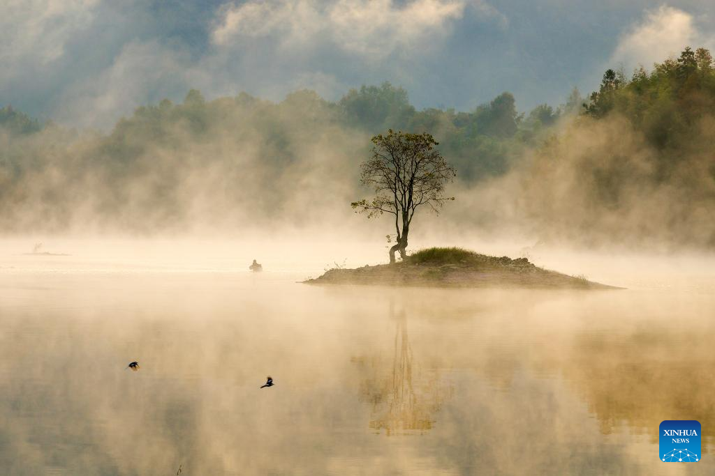 View of Qishu Lake shrouded in morning mist in Yixian County, China's Anhui