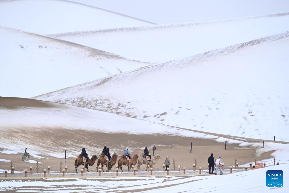 Tourists visit Mingsha Mountain and Crescent Spring Scenic Area in Dunhuang City, NW China
