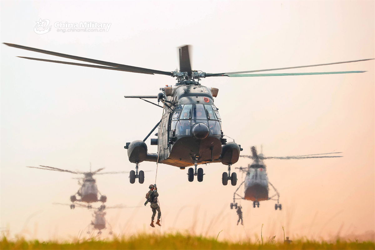 Army soldiers fast-rope from transport helicopters
