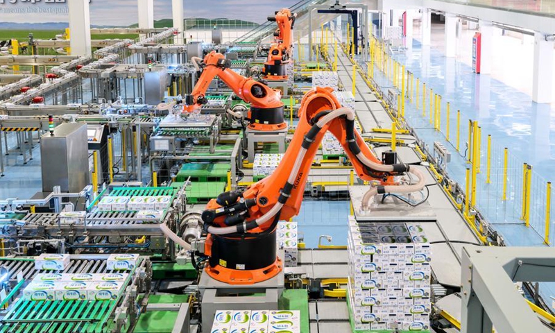 Robotic arms carry out packaging operation at the Global Intelligent Manufacturing Industrial Park of Yili Modern Intelligent Health Valley in Tumd Left Banner in Hohhot, north China's Inner Mongolia Autonomous Region, April 17, 2025. (Photo: Xinhua)