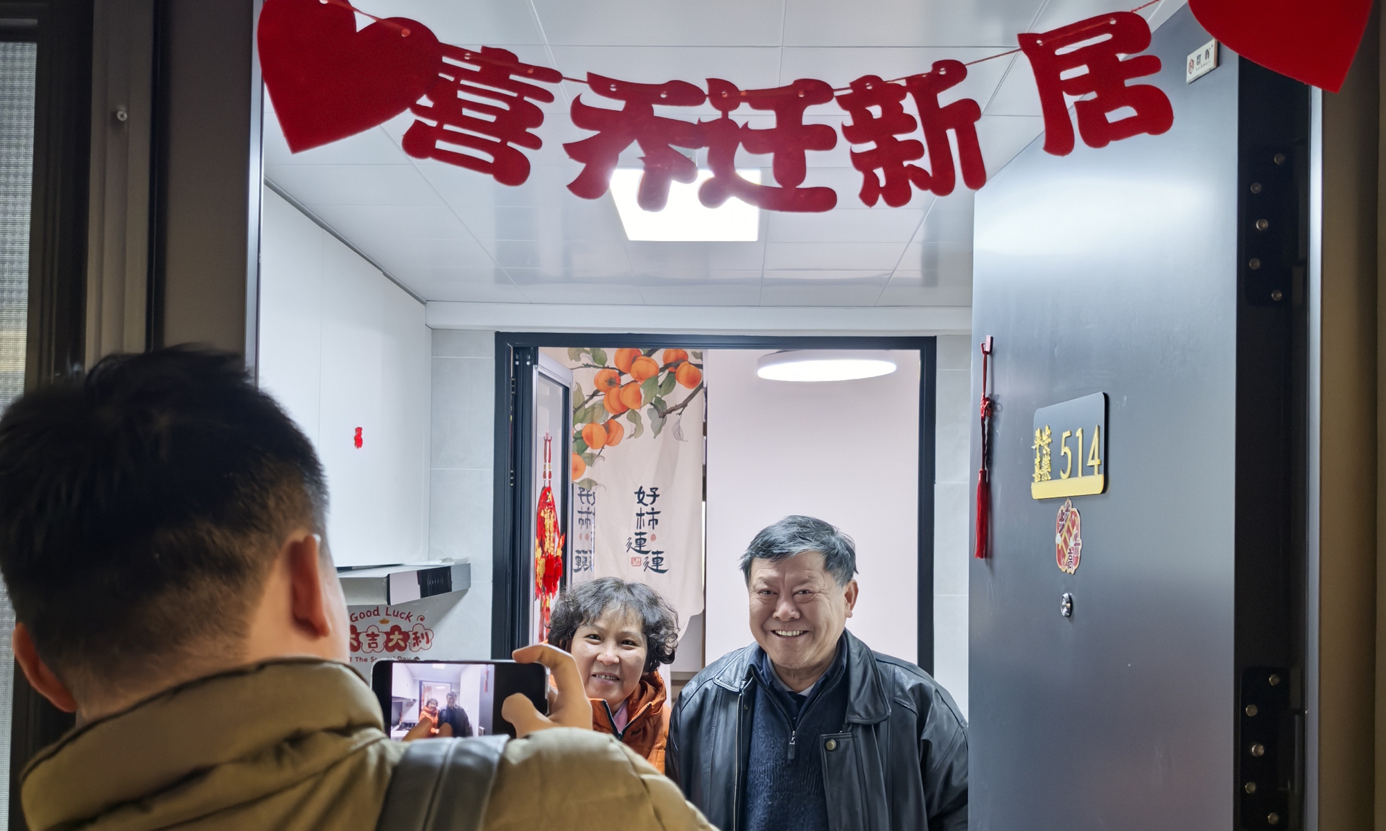 A People's Daily reporter takes photos of Yan Weiming and his wife, residents of Caoxi Third Village in Xuhui district, in Shanghai. Photo: Yin Xinyu/People's Daily