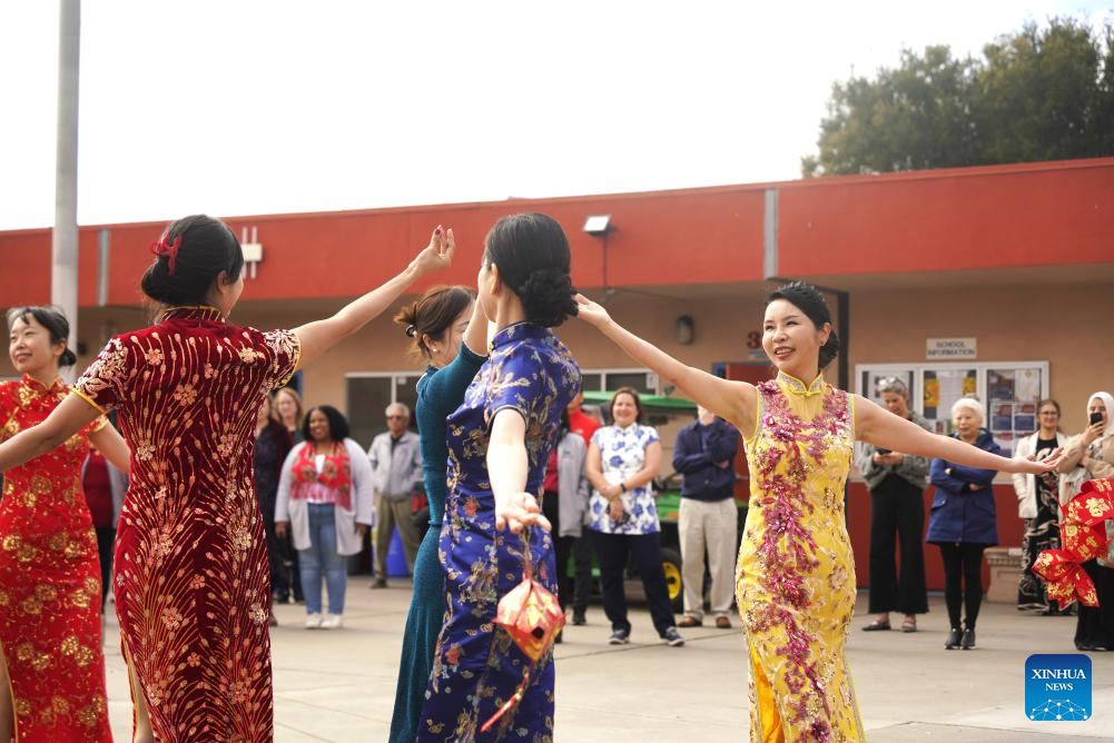 People in traditional Chinese Qipao perform during Lantern Festival celebration in U.S.