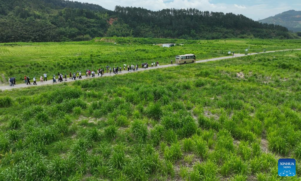 An aerial drone photo taken on May 17, 2025 shows guests visiting a Juncao base in Yongtai County, Fuzhou, southeast China's Fujian Province. Chinese and foreign guests attending the 20th International Conference on Juncao Industry Development learned about the development of Juncao industry in Fujian and exchanged experience.Juncao is a hybrid grass and a multifunctional agricultural resource developed in China and promoted globally. (Xinhua/Lin Shanchuan)
