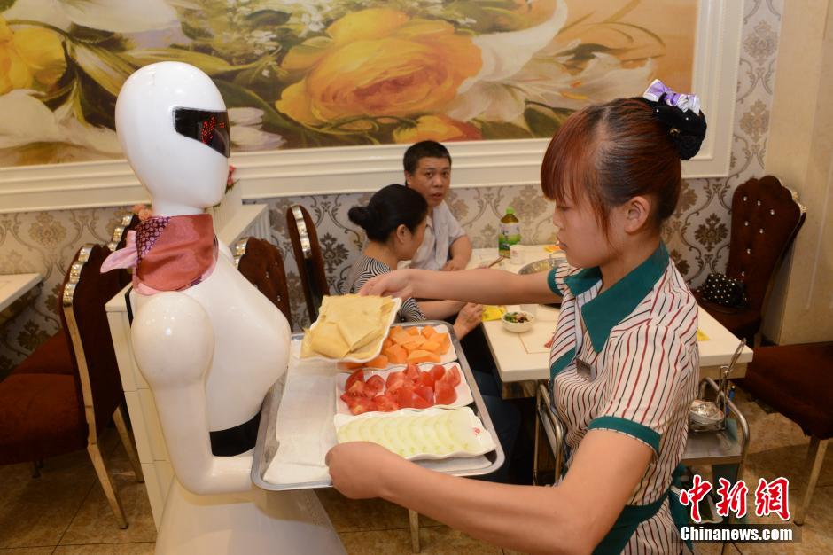 Robot waitress serves in hot pot restaurant in Chongqing