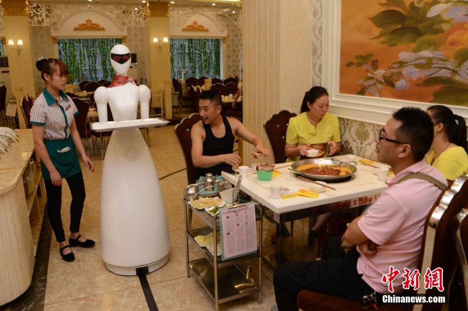 Robot waitress serves in hot pot restaurant in Chongqing