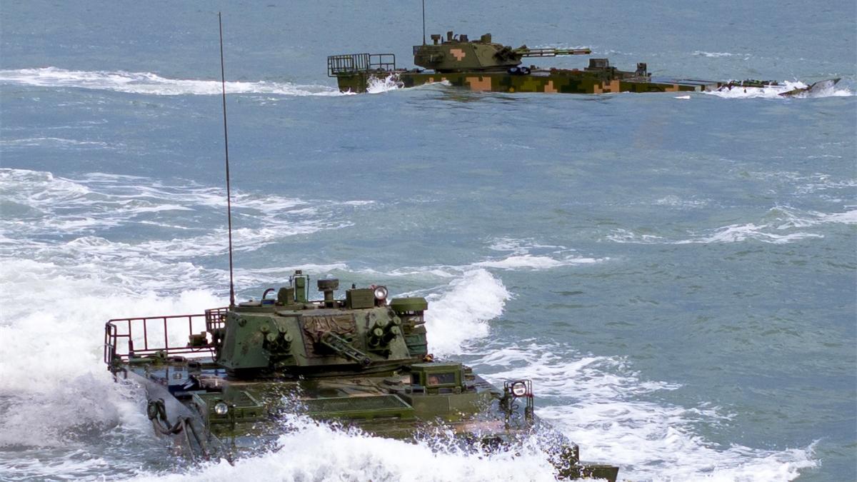 Amphibious infantry fighting vehicles (IFVs) steam in formation