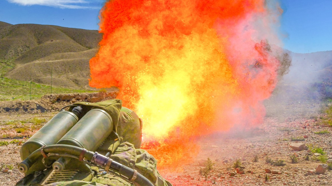 Soldiers shoot with flamethrower