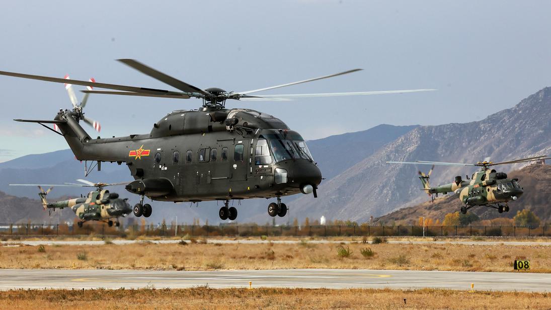 Multi-type helicopters fly over valley