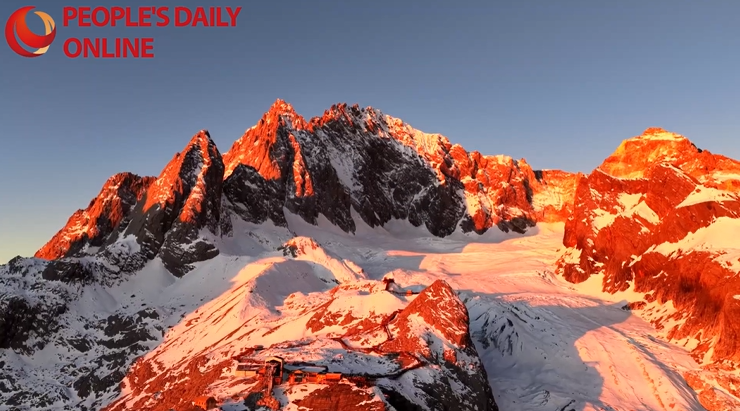 Yulong Snow Mountain glows in a spectacular winter golden sunrise