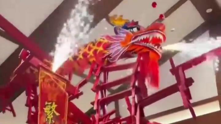 Acrobat balances dragon bench on head