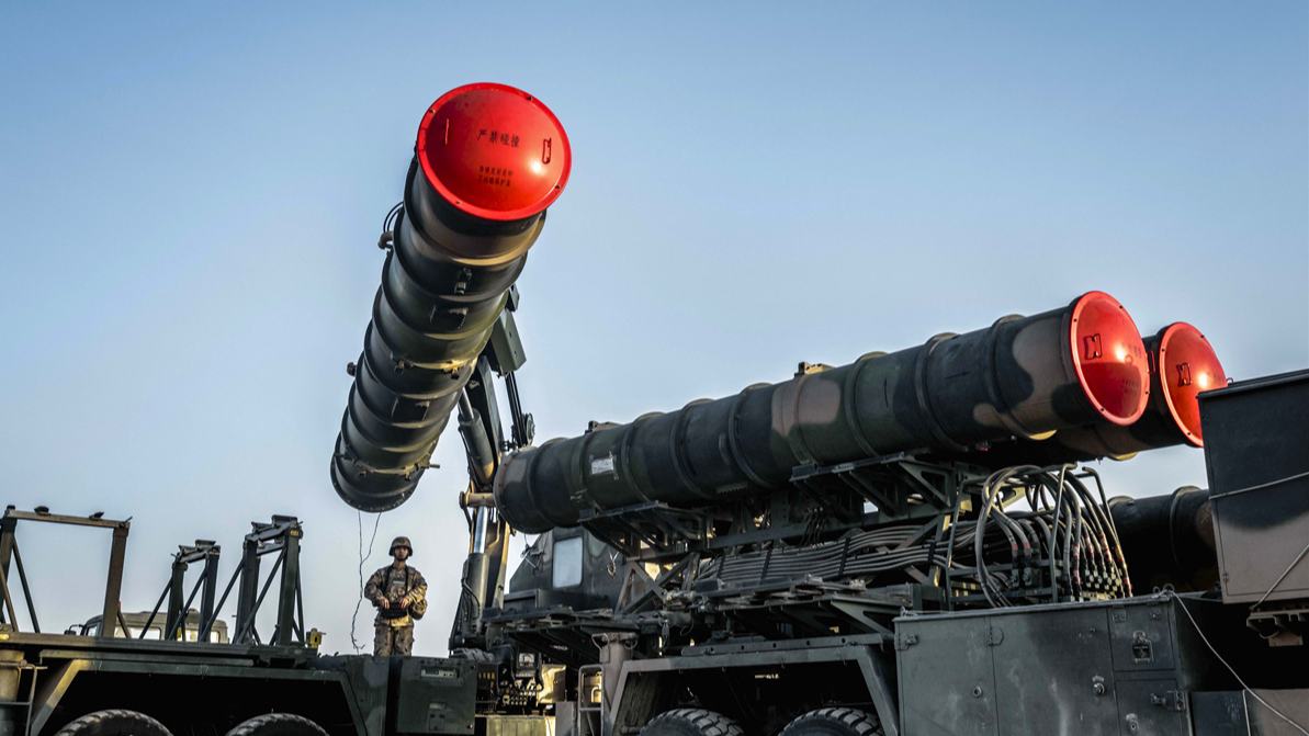 Soldiers hoist and load HQ-9 surface-to-air missile system