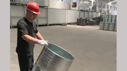 Warehouse worker spins oil drums with incredible precision