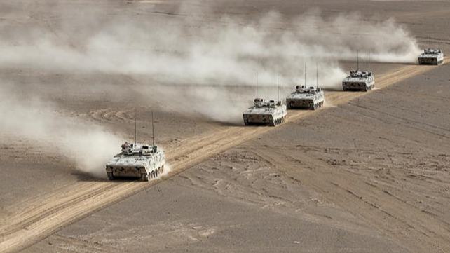 Armored vehicles en route to designated training area