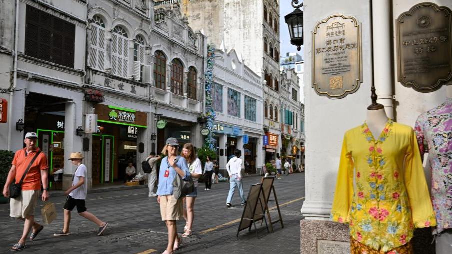 Foreign tourists visit Qilou Old Street in Haikou, S China's Hainan