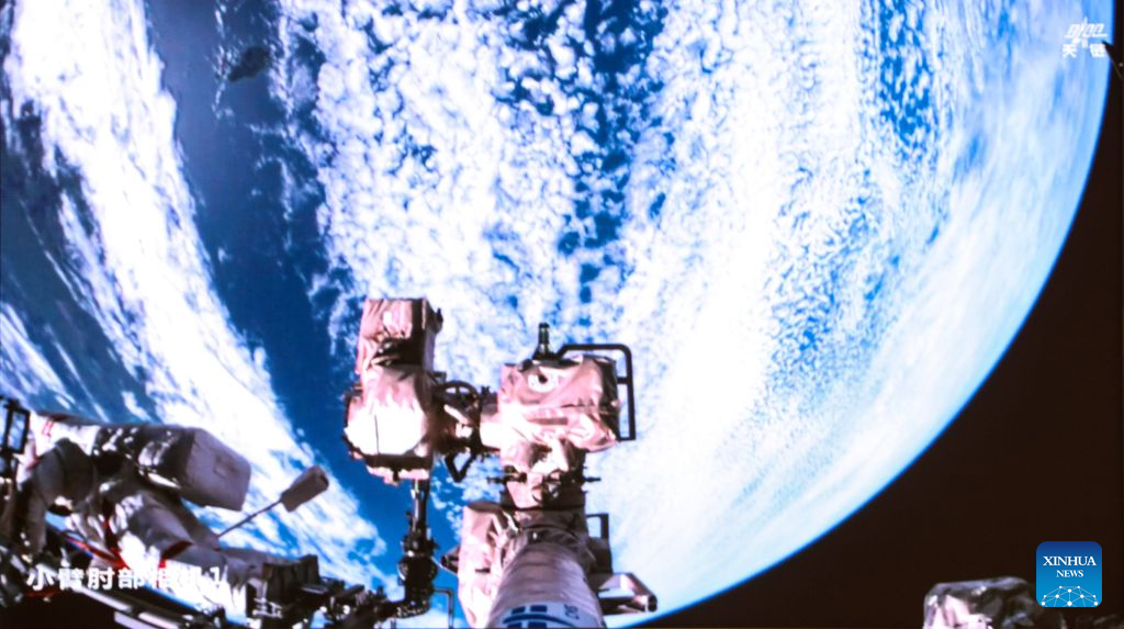 This screen image captured at Beijing Aerospace Control Center on Aug. 28, 2026 shows Shenzhou-23 astronaut Zhu Yangzhu performing extravehicular activities outside China's orbiting space station. The Shenzhou-23 crew aboard China's orbiting space station completed their mission's first series of extravehicular activities on Friday, according to the China Manned Space Agency (CMSA).  The astronaut trio -- Zhu Yangzhu, Zhang Zhiyuan and Li Jiaying -- worked for approximately 5.5 hours and completed their tasks at 1:59 p.m. (Beijing Time), assisted by the space station's robotic arm and ground support teams. Zhu, who previously spacewalked three years ago, made his second excursion, while Zhang ventured outside for the first time.  Zhu and Zhang installed debris shields and repaired the station's solar panels, ensuring the safety and stability of its power supply, according to the CMSA. This is the second time Chinese astronauts have performed such in-orbit maintenance tasks. (Photo by Yu Liqiang/Xinhua)