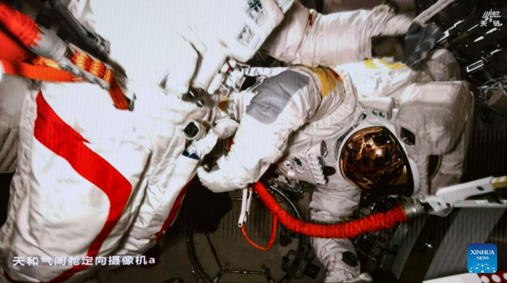This screen image captured at Beijing Aerospace Control Center on Aug. 28, 2026 shows Shenzhou-23 astronaut Zhu Yangzhu performing extravehicular activities outside China's orbiting space station. The Shenzhou-23 crew aboard China's orbiting space station completed their mission's first series of extravehicular activities on Friday, according to the China Manned Space Agency (CMSA).  The astronaut trio -- Zhu Yangzhu, Zhang Zhiyuan and Li Jiaying -- worked for approximately 5.5 hours and completed their tasks at 1:59 p.m. (Beijing Time), assisted by the space station's robotic arm and ground support teams. Zhu, who previously spacewalked three years ago, made his second excursion, while Zhang ventured outside for the first time.  Zhu and Zhang installed debris shields and repaired the station's solar panels, ensuring the safety and stability of its power supply, according to the CMSA. This is the second time Chinese astronauts have performed such in-orbit maintenance tasks. (Photo by Yu Liqiang/Xinhua)