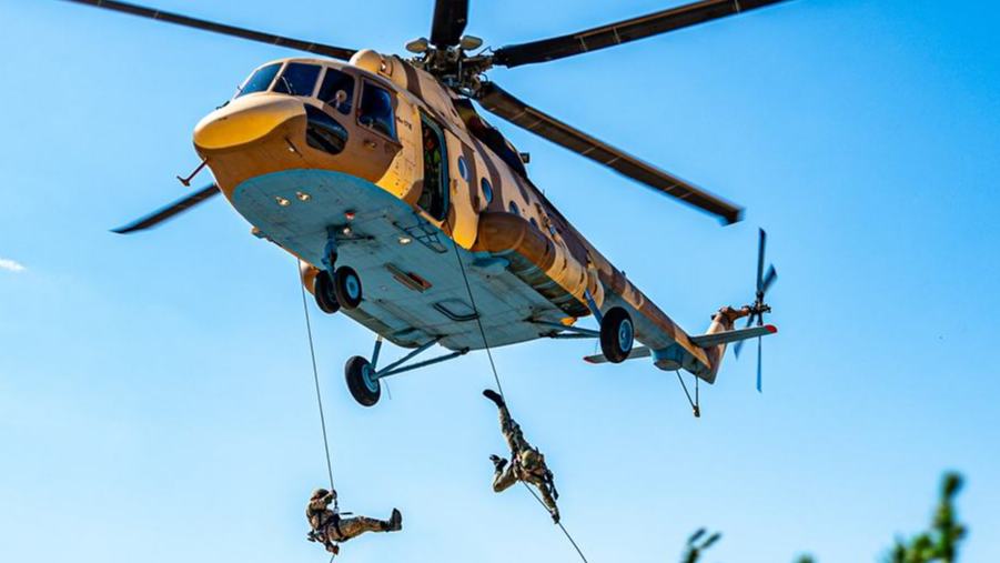 Soldiers fast-rope from Mi-171E helicopters